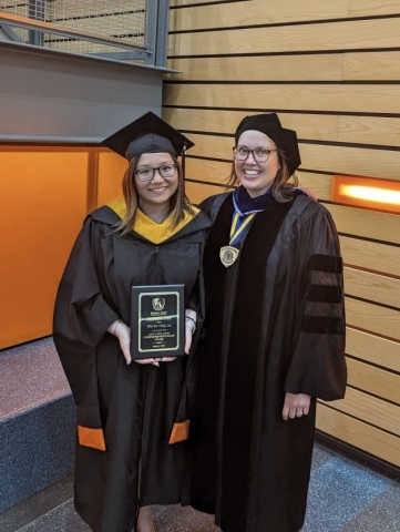 Vicky Lee and Angela Thering in graduation regalia