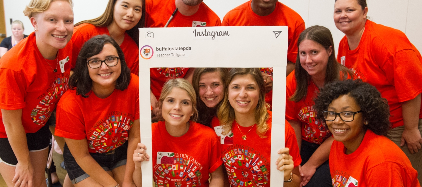 group of students in orange tshirts
